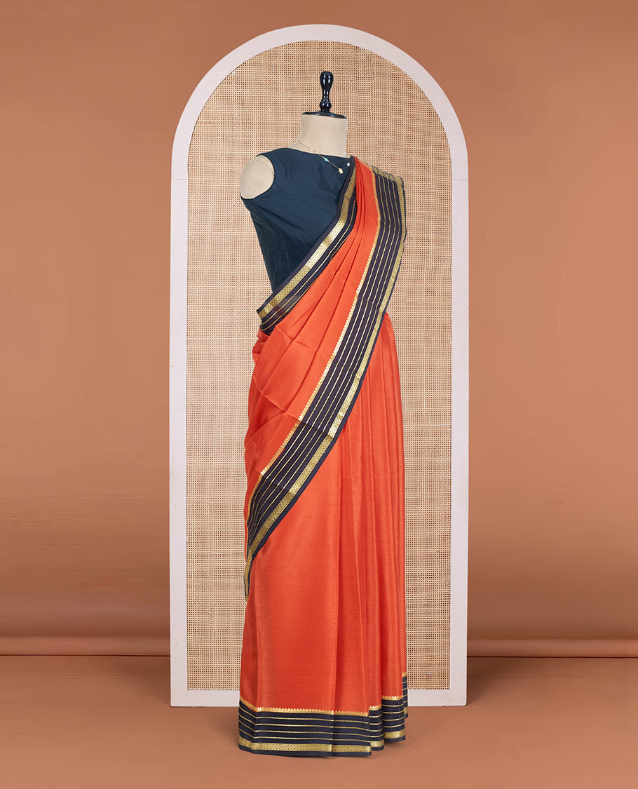 Orange Plain Mysore Silk Saree, Complemented by a Contrast Varisai Pettu Border of Traditional Zari Designs, a Subtly Sparkled Pallu of Zari Stripes, and a Contrast Blouse