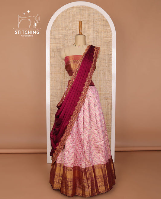 Light pink chevron design tissue half saree with contrast intricate zari design border, zari design blouse & scallop embroidery dhavani