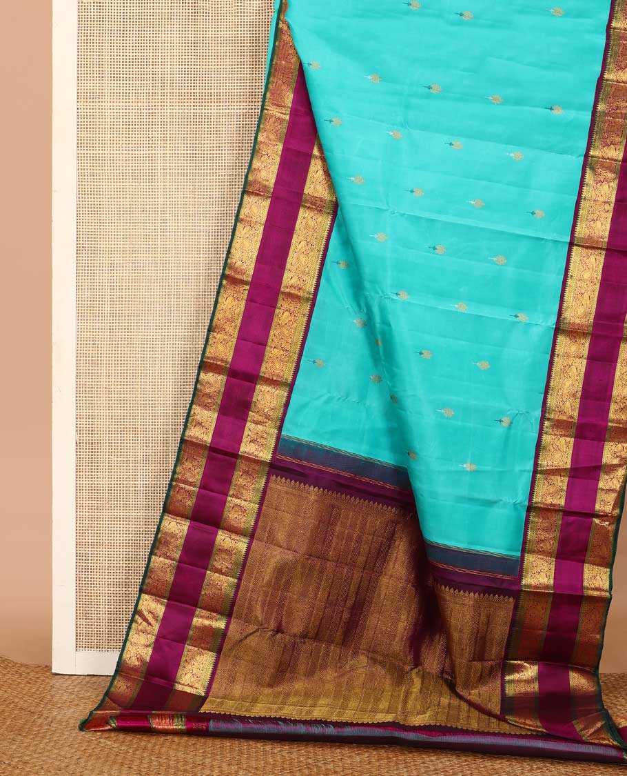 Blue meena buttas Kanchipuram silk saree, contrast korvai border of thilakam mokku, rettai neli, and mayil designs, and geometric patterned pallu