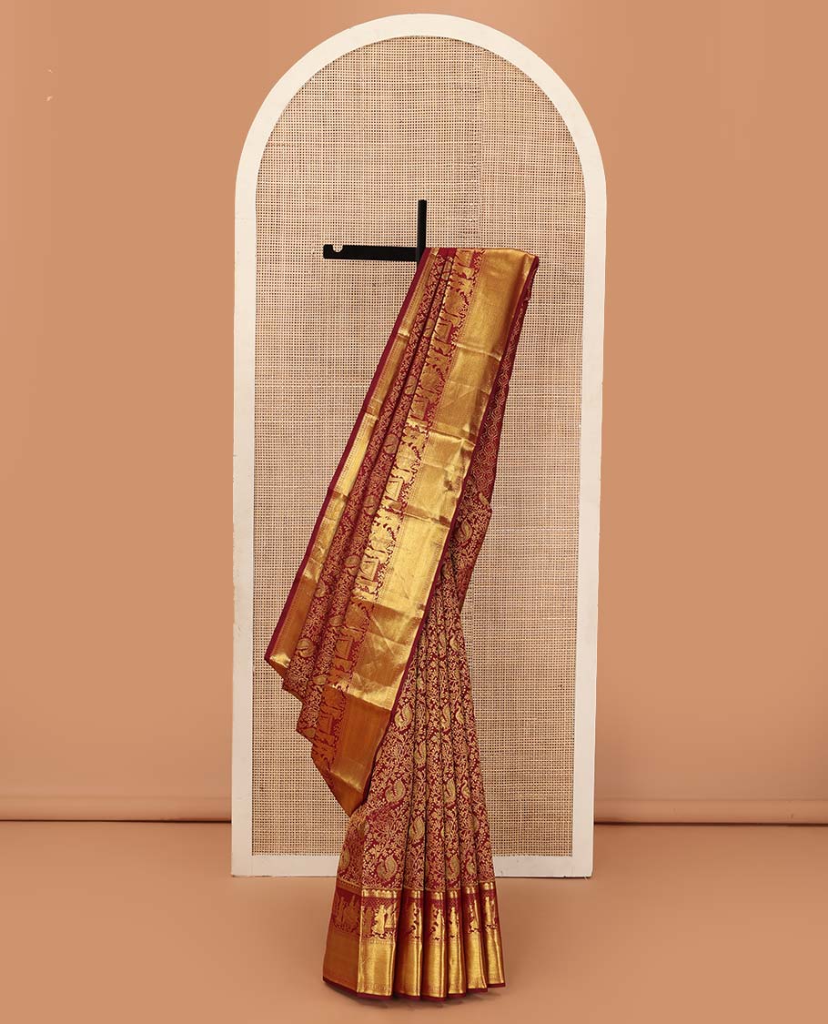 Maroon jacquard wedding silk saree, traditional zari border of wedding palanquin design, and butta enclosed hexogon grid pallu