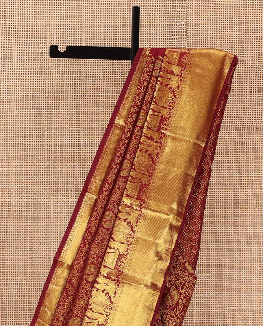Maroon jacquard wedding silk saree, traditional zari border of wedding palanquin design, and butta enclosed hexogon grid pallu