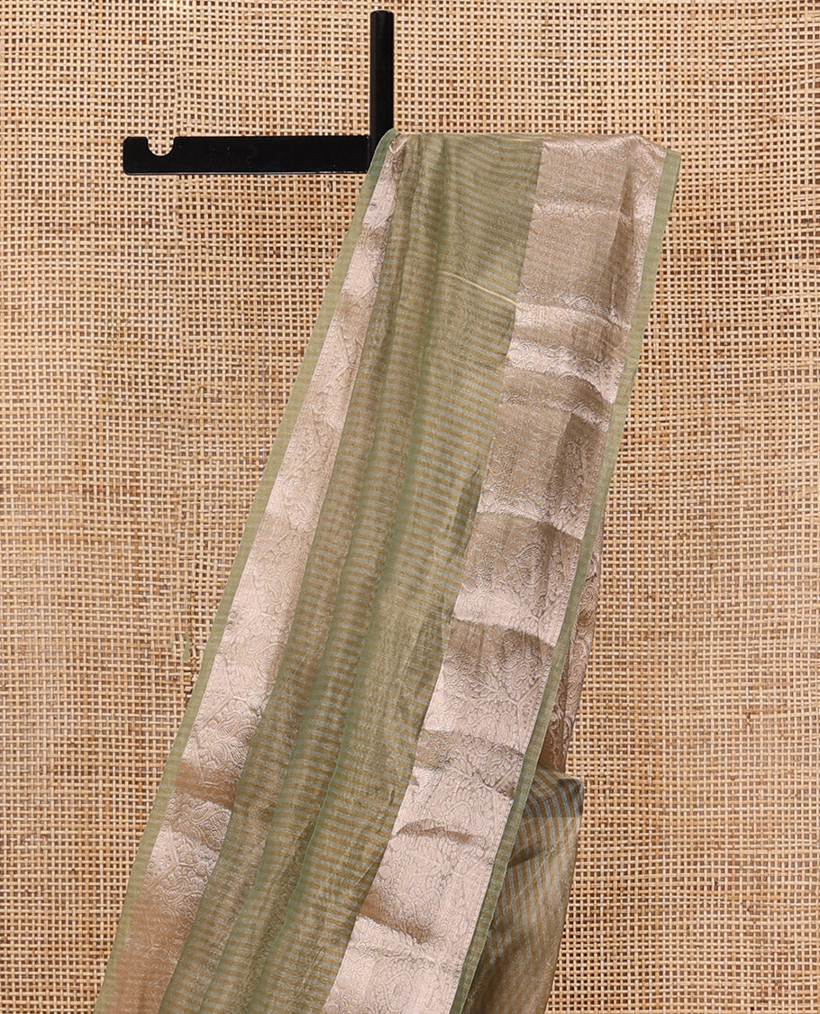 Pastel green sparesely striped tissue saree, Mughal style zari woven border, and intricately zari woven pallu