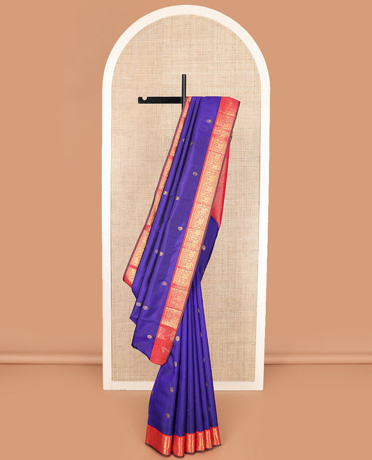 Blue mayil buttas Kanchipuram silk saree, contrast border of thilakam mokku, muthu, and mayil designs, and jaal pallu