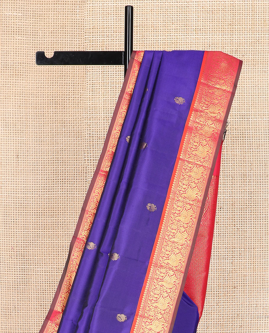 Blue mayil buttas Kanchipuram silk saree, contrast border of thilakam mokku, muthu, and mayil designs, and jaal pallu