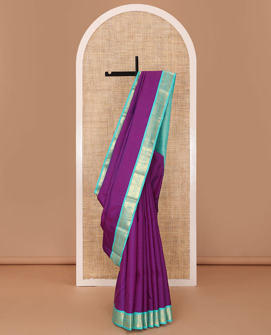 Purple plain Kanchipuram silk saree, contrast korvai border of thilakam mokku, muthu, vanki, lavangam, neli, diamond, and manga designs, and jaal pallu