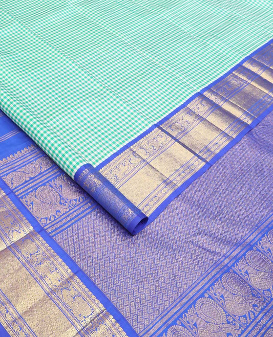 Blue micro-checked Kanchipuram silk saree, contrast korvai border of manga mokku,kathir,muthu,manga and mayil and jaal pallu