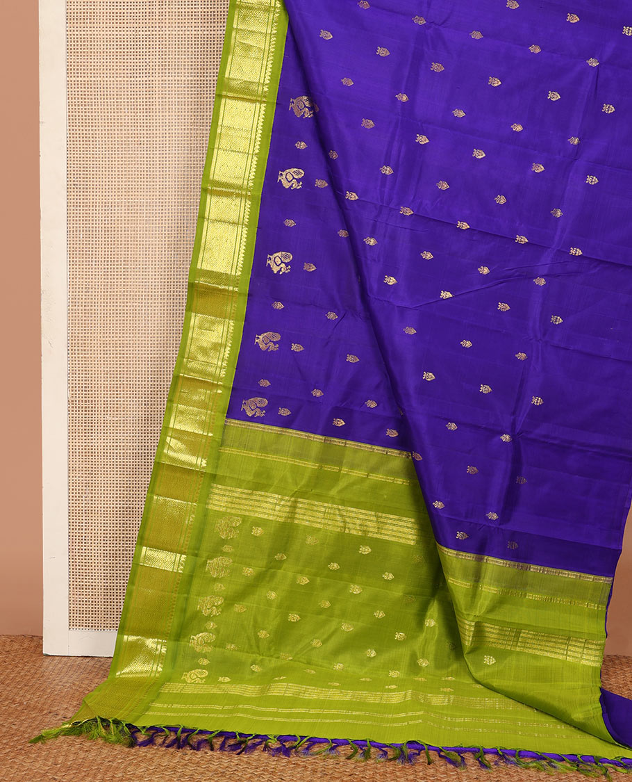 Blue zari buttas Kanchipuram silk saree, contrast one-sided border of thilakam mokku, banaras, and jaal designs, and pallu of mayil motifs