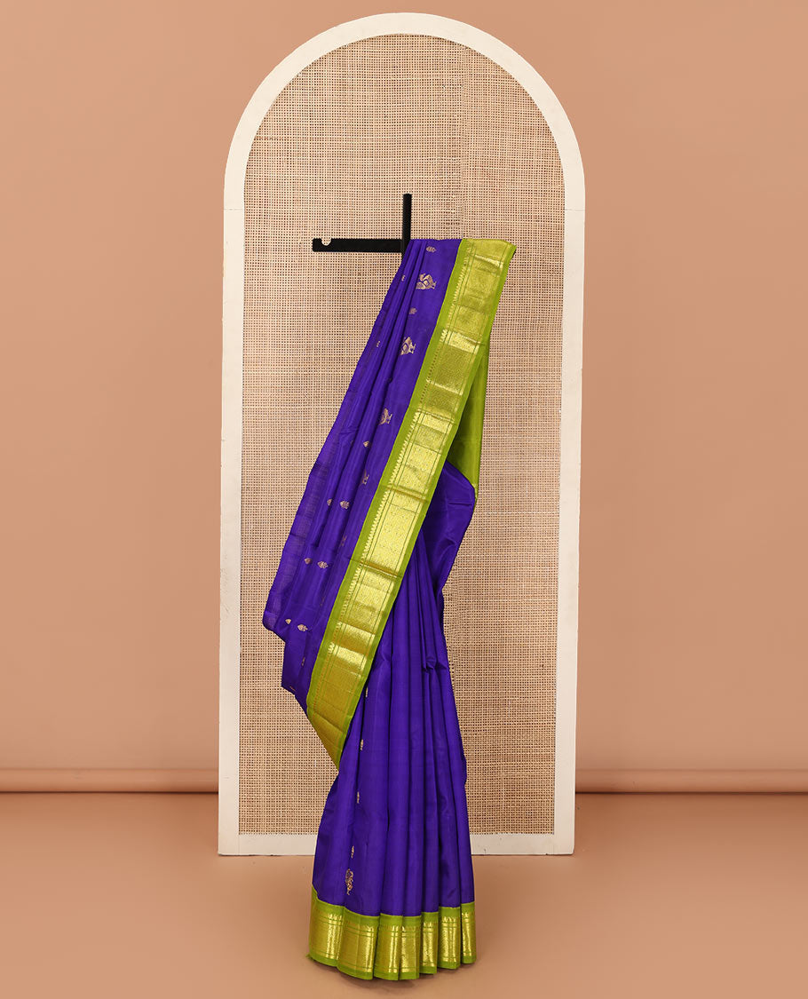 Blue zari buttas Kanchipuram silk saree, contrast one-sided border of thilakam mokku, banaras, and jaal designs, and pallu of mayil motifs