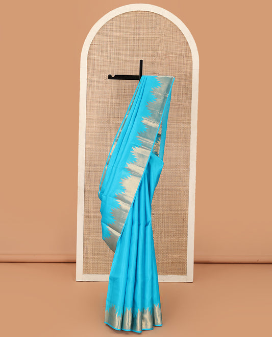 Sky blue plain Kanchipuram silk saree, thazampoo rekku zari border, and pallu of mayil kann