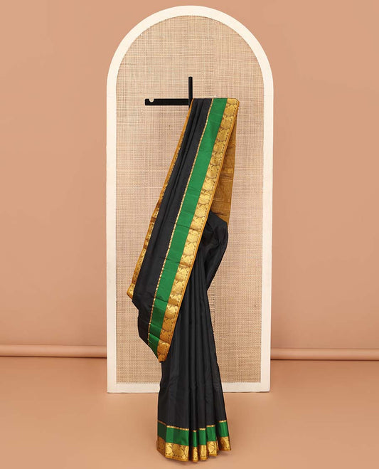 Black striped Kanchipuram silk saree, contrast rettai pettu border of salngai, and mayil designs, and pallu of stripes, and thazampoo rekku designs