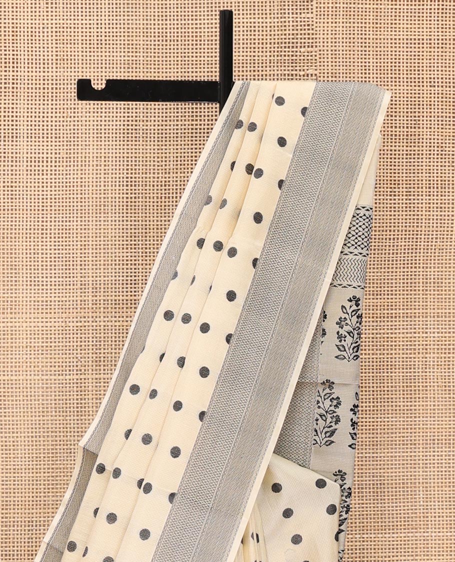 Cream Mayuri Soft Silk Saree, Accentuated with Polka Dot Buttas All Over Its Body, Sparsely Woven Geometric Patterned Border, Pallu Steeped with Floral Designs, and Paired with a Matching Blouse