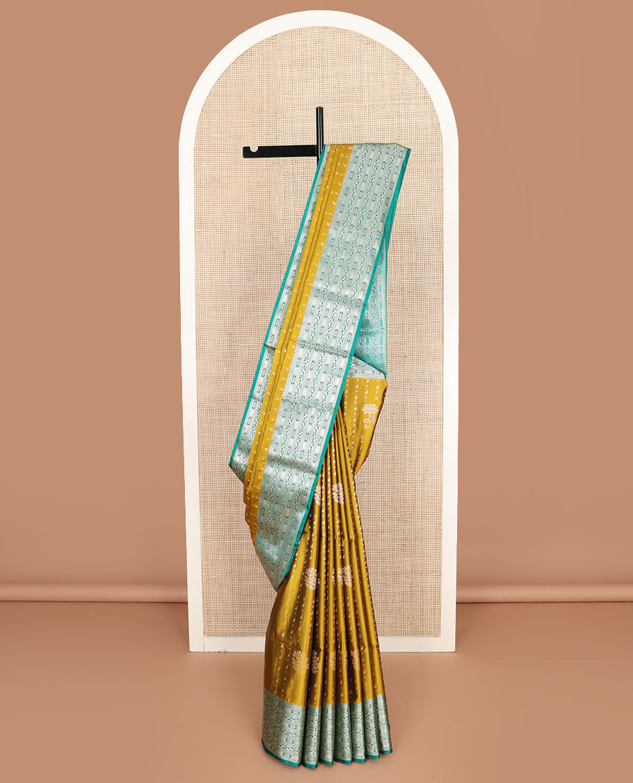 Mustard floral buttas soft silk saree, contrast traditional zari design border, and pallu of geometric patterns
