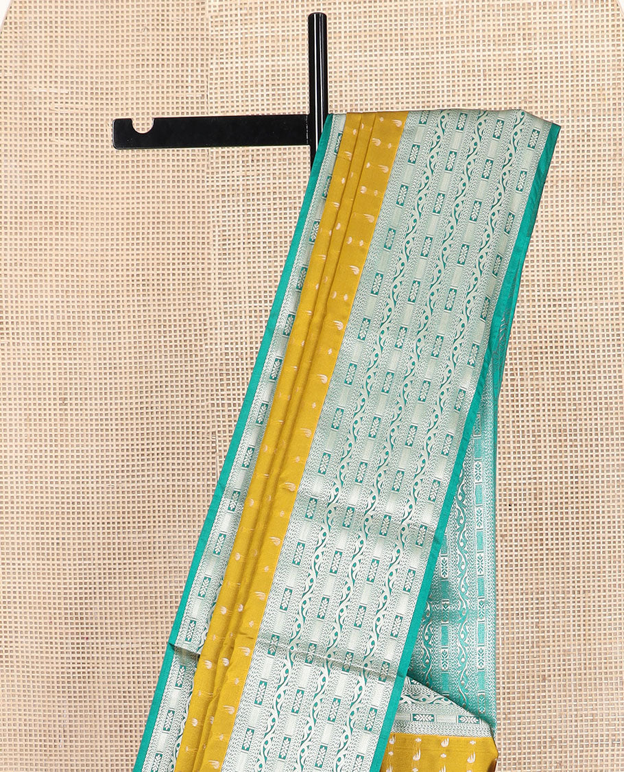 Mustard floral buttas soft silk saree, contrast traditional zari design border, and pallu of geometric patterns