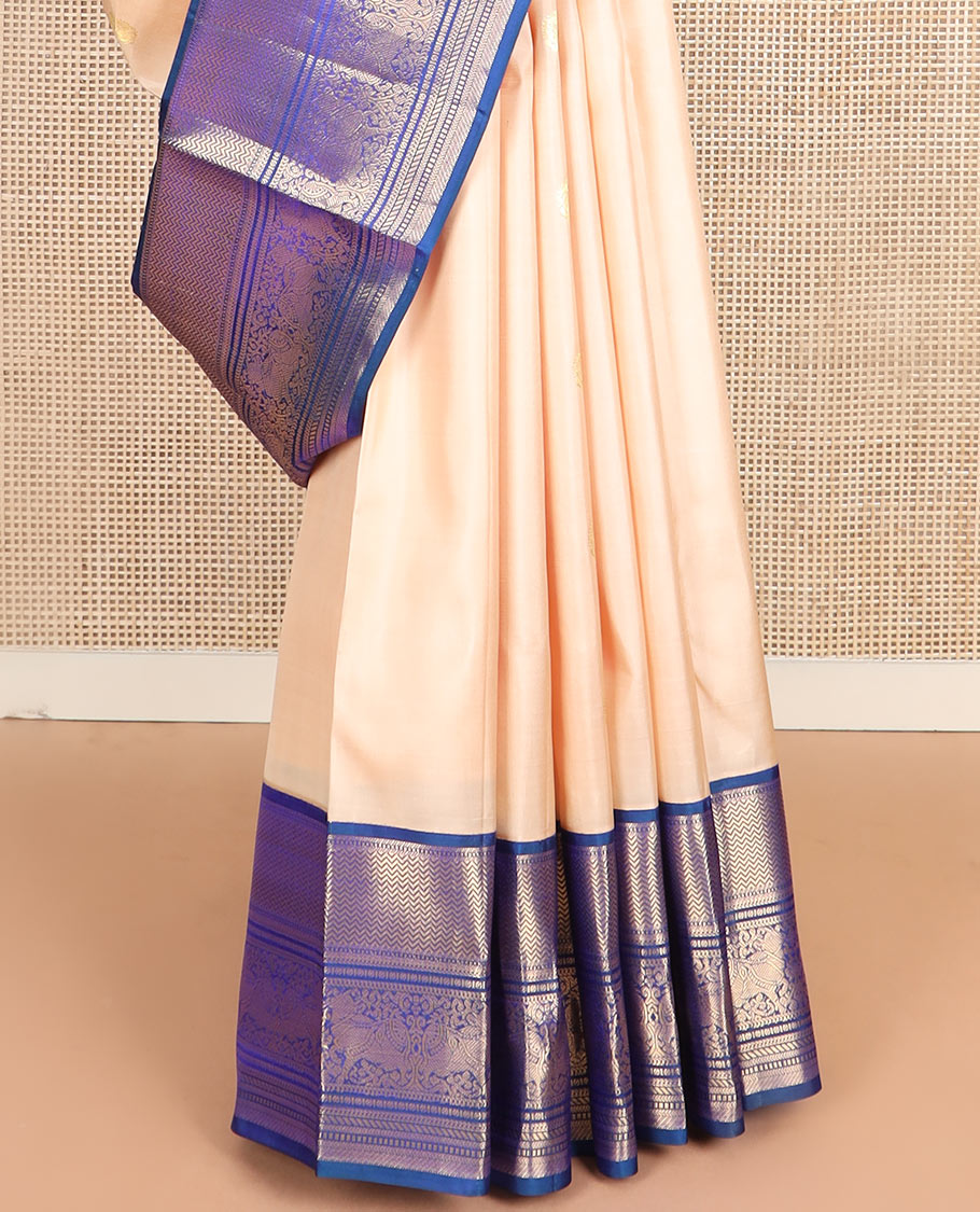 Light sandal zari buttas silk saree, contrast border of vanki, banaras, muthu, kathir, and Pichwai cow motifs zari weave, and pallu of manga designs