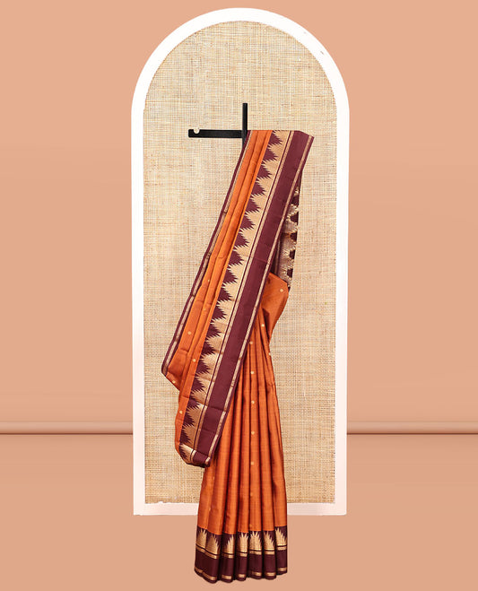 Orange Vasundhara Silk Saree, Delicately Woven with Zari Buttas, Complemented by a Contrast Rettai Pettu Border of Thazampoo Rekku Designs, Vanki Pallu, and a Contrast Blouse