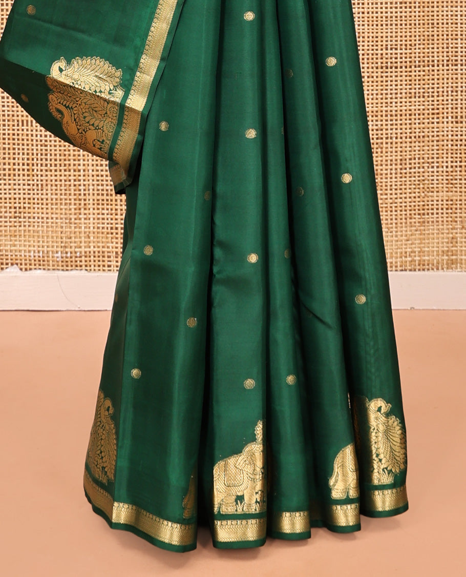 Green Vasundhara Silk Saree, Majestically Detailed with Zari Buttas and Mayil-Yaanai Buttas, a Subtle Zari Border, Jaal Pallu, and a Matching Blouse