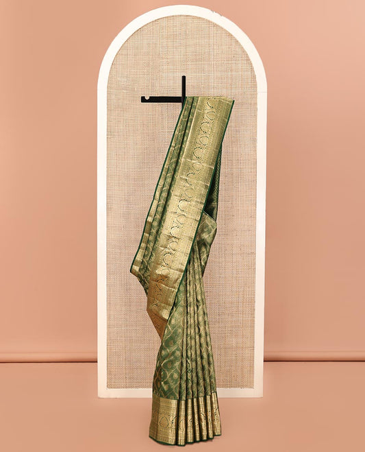 Green Kanchipuram Wedding Silk Saree, Elevated with Jacquard Designs on Its Body, Highlighted by a Traditional Zari Border of Kuthirai, Chakram, and Mayil Designs, Pallu of Greek Key Designs, and Paired with a Matching Blouse