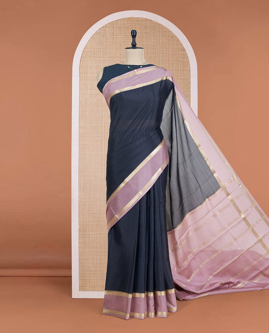 Black Plain Mysore Silk Saree, Complemented by a Contrast Rettai Pettu Border of Traditional Zari Designs, a Subtly Sparkled Pallu of Zari Stripes, and a Contrast Blouse