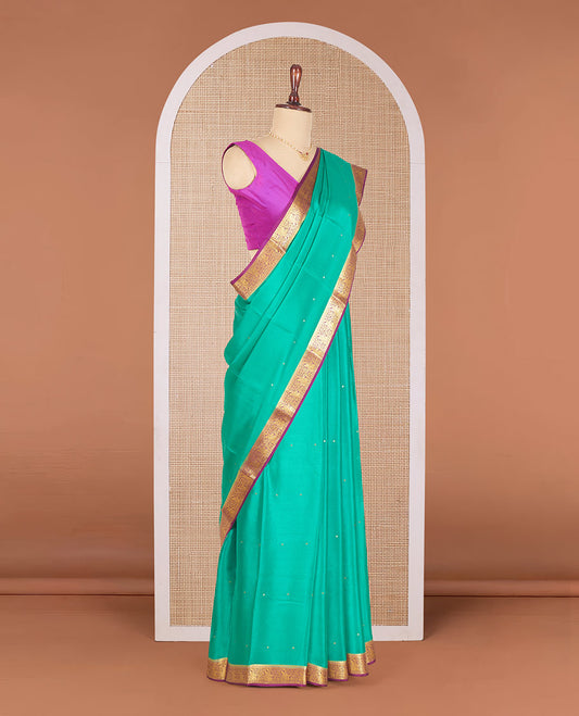 Persian Green Mysore Silk Saree Accentuated with Zari Buttas All Over the Saree, Complemented by Contrast Border of Paisley Designs, Pallu Steeped with Zari Buttas, and Paired with a Contrast Blouse