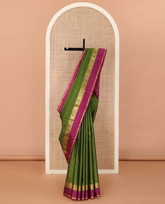 Green Kanchipuram Silk Saree, Sparsely Sparkled with Vazhaipoo Stripes, Complemented by Contrast Rettai Pettu Border of Round Mayil, and Paisa Designs, Zari Stripes Woven Pallu, and Paired with a Contrast Blouse