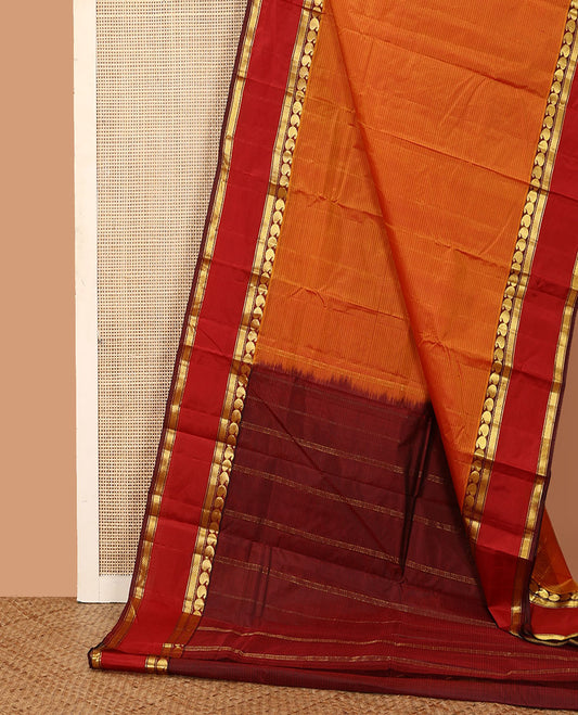Orange striped Kanchipuram silk saree, contrast rettai pettu border of manga and mayil kann designs, and zari striped pallu