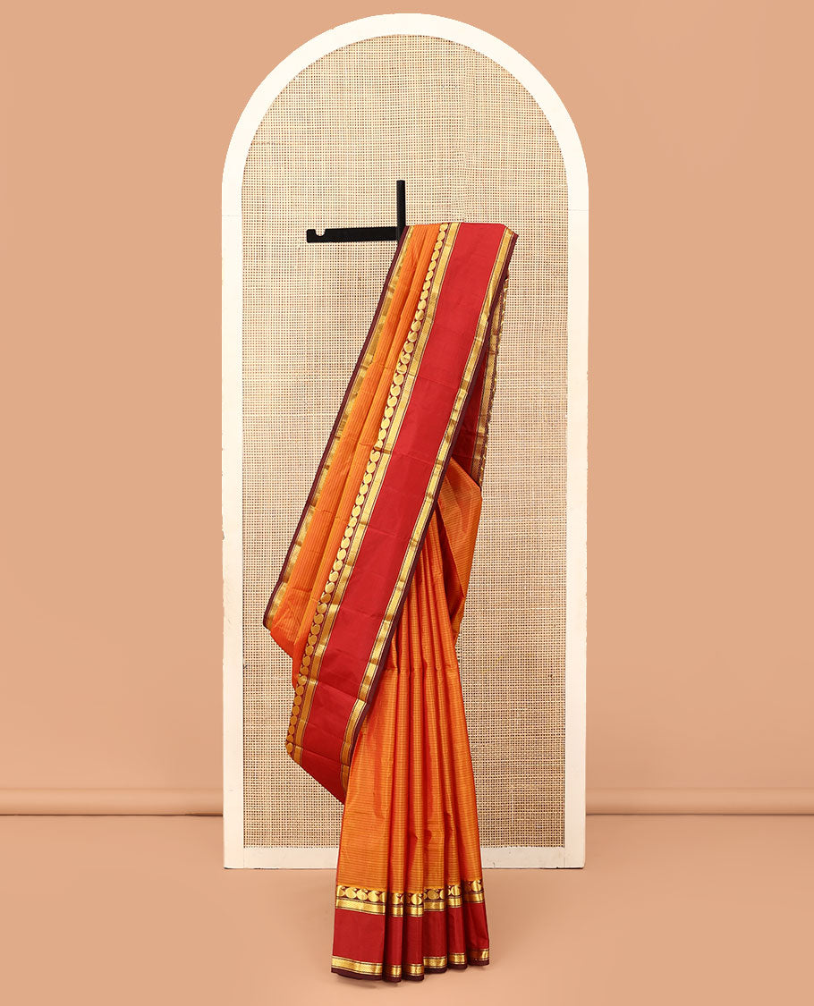 Orange striped Kanchipuram silk saree, contrast rettai pettu border of manga and mayil kann designs, and zari striped pallu