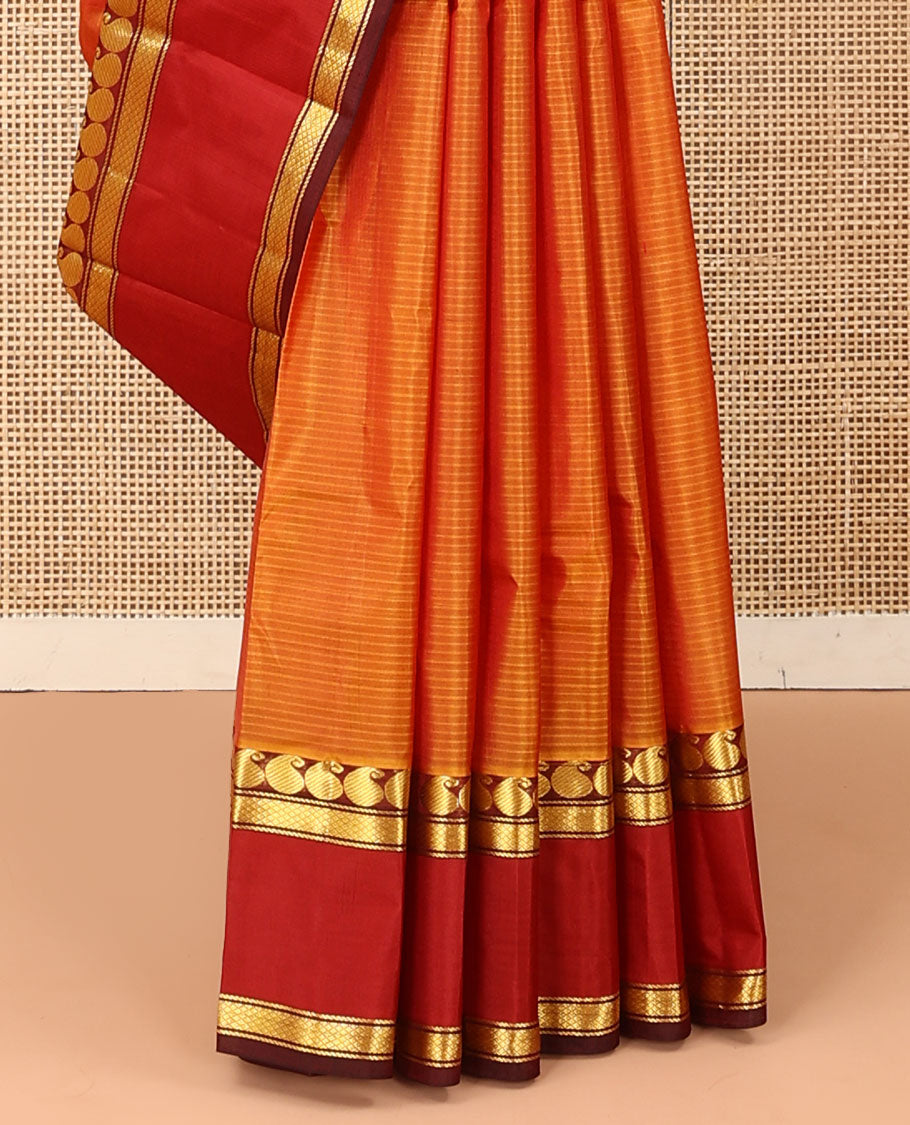 Orange striped Kanchipuram silk saree, contrast rettai pettu border of manga and mayil kann designs, and zari striped pallu