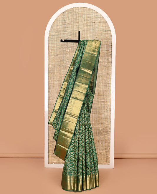 Green zari buttas woven kanchipuram silk saree, zari border of salngai, kamalam, yaali, yaanai, and mayil kann designs, and jaal pallu