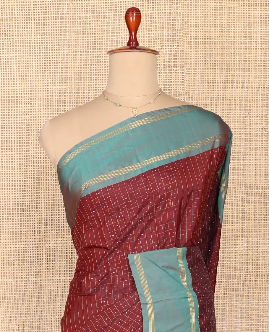 Maroon Aarani Silk Saree, Enriched with Butta Enclosed Checked Design on Its Body, Complemented by a Contrast Zari Striped Border, Pallu of Butta Enclosed Checks, and Paired with a Matching Blouse