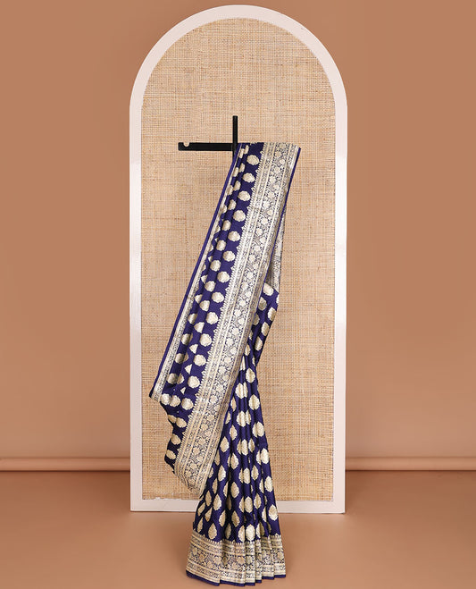 Navy blue banarasi silk saree with zari buttas, self-border of floral creeper designs & pallu steeped with floral designs
