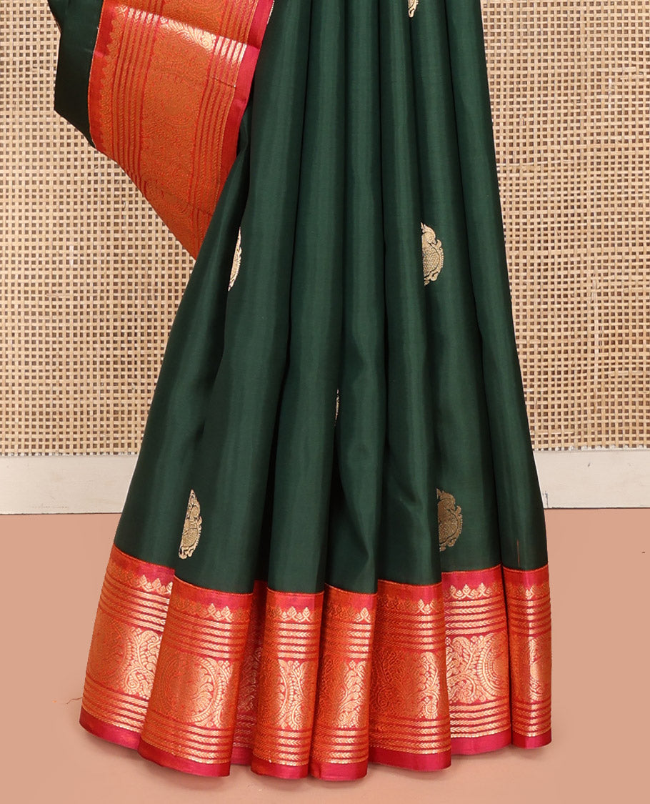 Green Vasundhara Silk Saree, Elevated with Mayil Zari Buttas All Over Its Body, Complemented by a Contrast  Border of Thilakam Mokku, Kathir, and Round Mayil Designs, Grand Jaal Pallu, and Paired with a Contrast Blouse