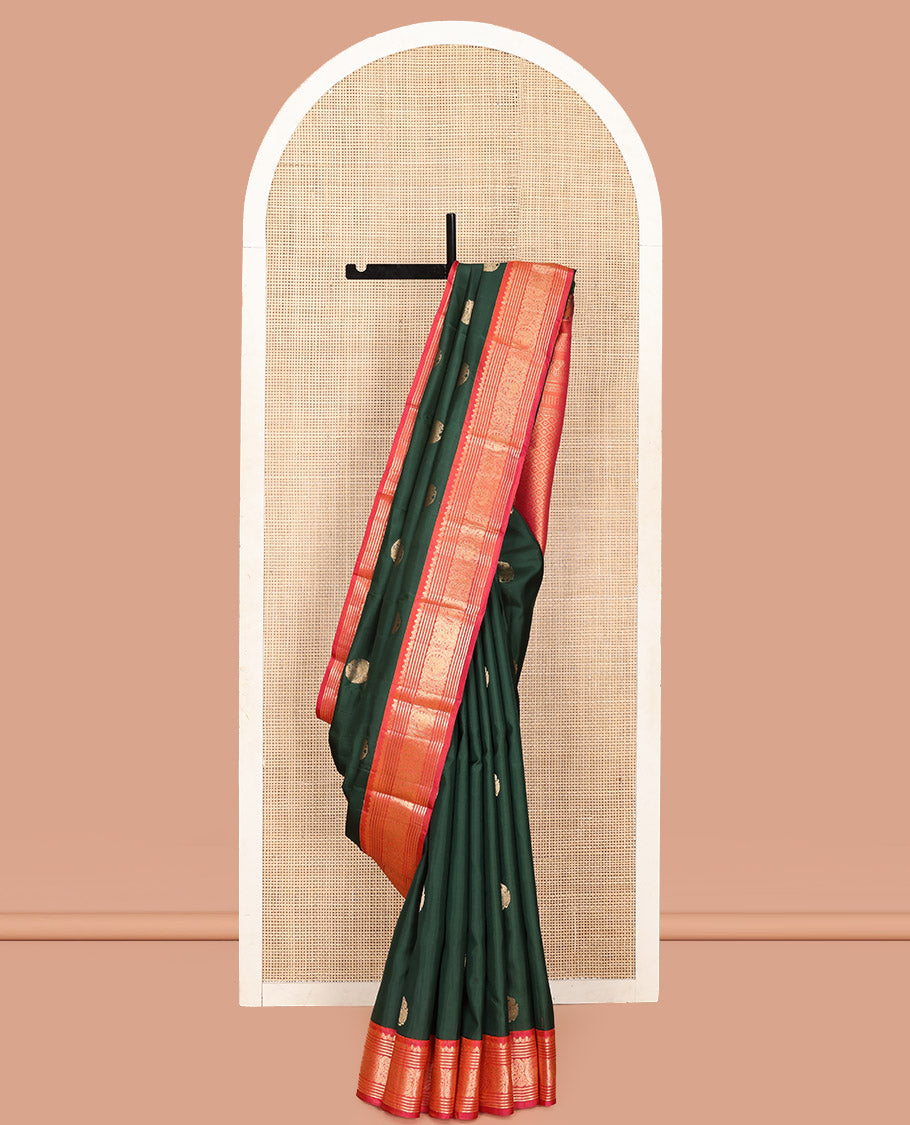 Green Vasundhara Silk Saree, Elevated with Mayil Zari Buttas All Over Its Body, Complemented by a Contrast  Border of Thilakam Mokku, Kathir, and Round Mayil Designs, Grand Jaal Pallu, and Paired with a Contrast Blouse