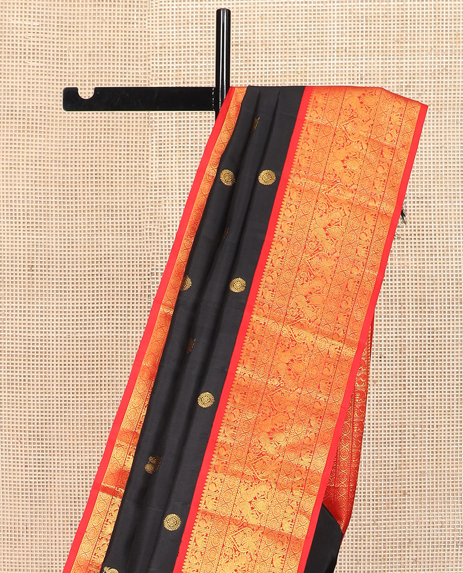 Black mayil chakram buttas Kanchipuram silk saree, contrast border of thilakam mokku, mayil, yaanai, and chakram designs, and chakram design pallu