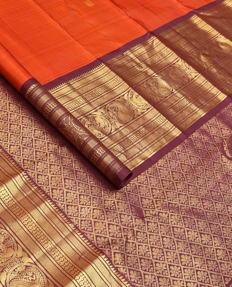 Orange annam chakram buttas Kanchipuram silk saree, contrast border of rekku, banaras, vanki, round mayil, and round manga, and jaal pallu