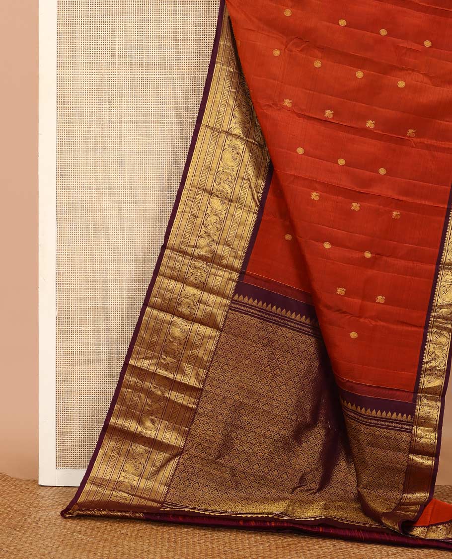 Orange annam chakram buttas Kanchipuram silk saree, contrast border of rekku, banaras, vanki, round mayil, and round manga, and jaal pallu