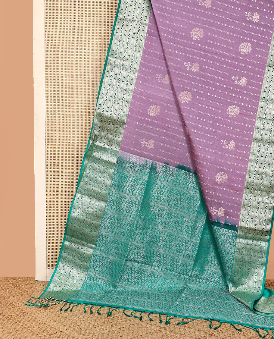 Purple floral buttas soft silk saree, contrast traditional zari design border, and pallu of geometric patterns