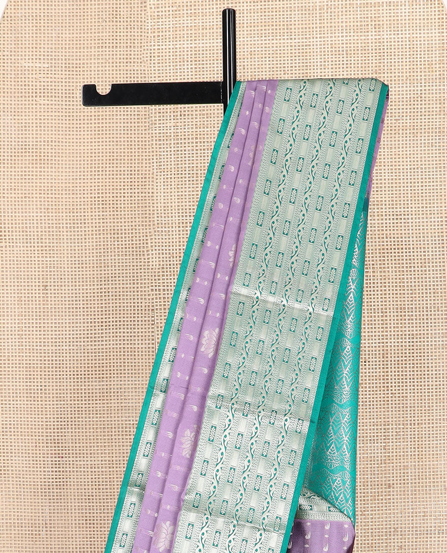 Purple floral buttas soft silk saree, contrast traditional zari design border, and pallu of geometric patterns