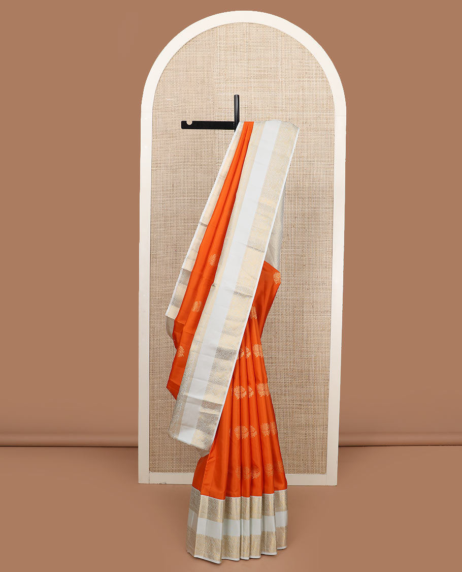 Orange zari buttas silk saree, contrast rettai pettu border of thilakam mokku, kamalam, and mayil designs, and jaal pallu