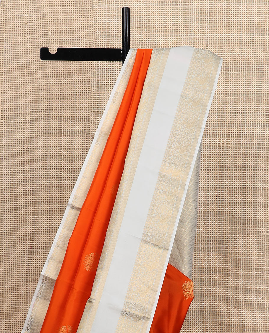 Orange zari buttas silk saree, contrast rettai pettu border of thilakam mokku, kamalam, and mayil designs, and jaal pallu