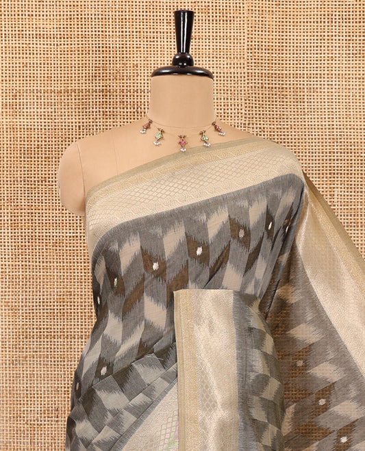 Grey zig-zag style ikkat design with buttas Munga cotton saree, zari jacquard blouse, ogee patterned pallu, and a contrast border of thread and zari buttas