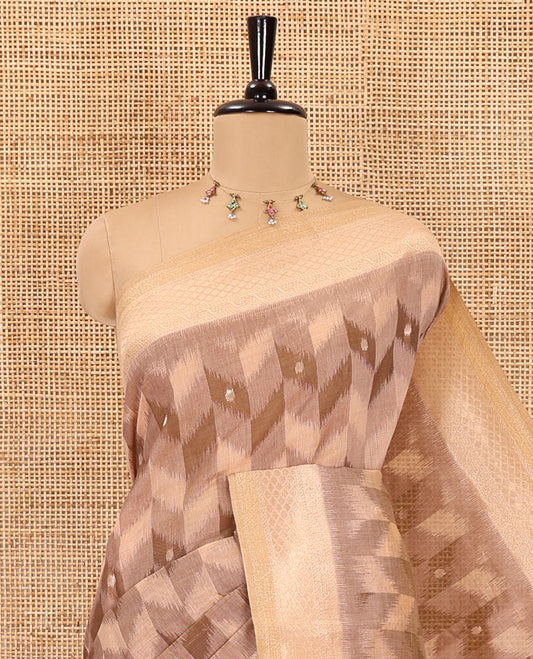 Peach zig-zag style ikkat design with buttas Munga cotton saree, zari jacquard blouse, ogee patterned pallu, and a contrast border of thread and zari buttas