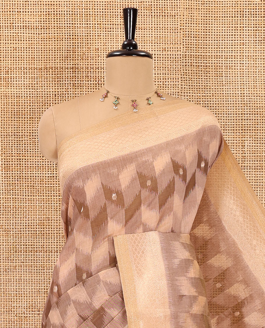 Peach zig-zag style ikkat design with buttas Munga cotton saree, zari jacquard blouse, ogee patterned pallu, and a contrast border of thread and zari buttas