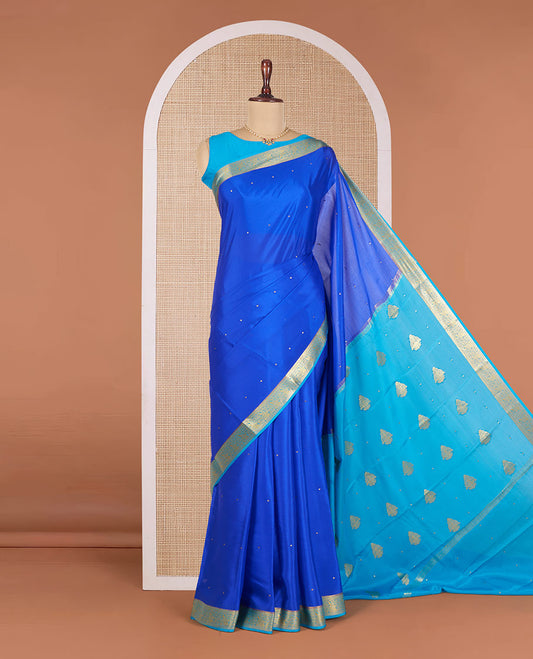 Royal Blue Mysore Silk Saree Accentuated with Zari Buttas All Over the Saree, Complemented by Contrast Border of Paisley Designs, Pallu Steeped with Zari Buttas, and Paired with a Contrast Blouse