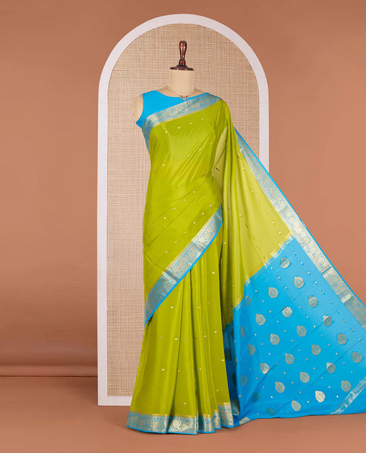 Parrot Green Mysore Silk Saree Bedecked with Zari Buttas All Over the Saree, Complemented by Contrast Border of Floral Creeper Designs, Pallu Steeped with Zari Designs, and Paired with a Contrast Blouse