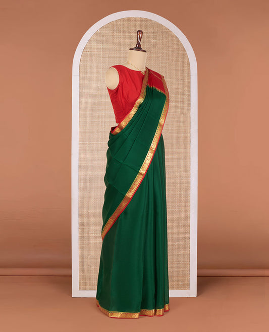 Dark Green Plain Mysore Silk Saree, Complemented by Contrast Border of Intricate Designs, Pallu Steeped with Zari Stripes, and Paired with a Contrast Blouse
