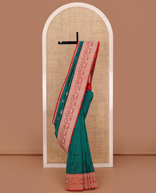Green floral buttas katan silk saree, contrast traditional border of flora-fauna designs, and pallu of peacock, and derr motifs enclosed circles