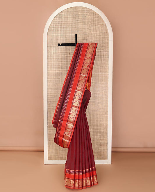 Maroon thread buttas Kanchipuram silk saree, contrast rettai pettu border of rekku, rudraksham, yaanai, and Pichwai cow designs, and pallu features Vrishabha Kunjara design