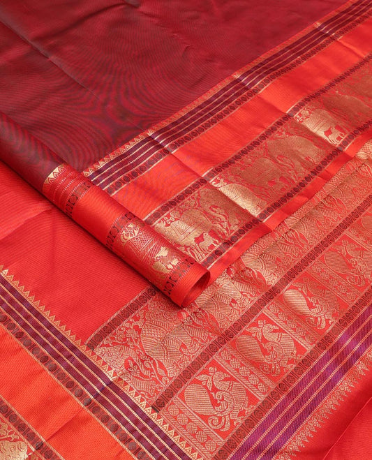 Maroon thread buttas Kanchipuram silk saree, contrast rettai pettu border of rekku, rudraksham, yaanai, and Pichwai cow designs, and pallu features Vrishabha Kunjara design