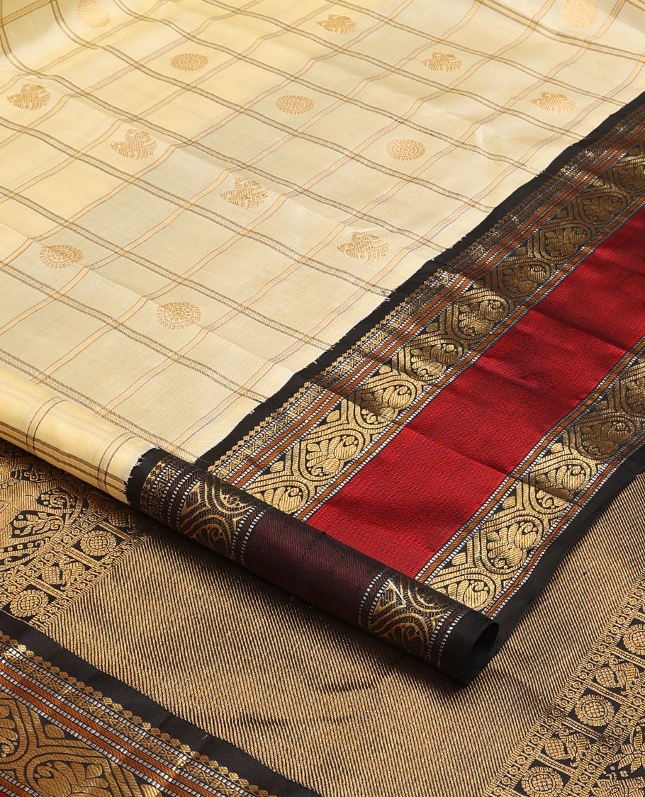 Cream iruthalai pakshi, and chakram buttas enclosed zari checked Kanchipuram silk saree, contrast rettai pettu border of salngai, muthu, and jadai nagam designs