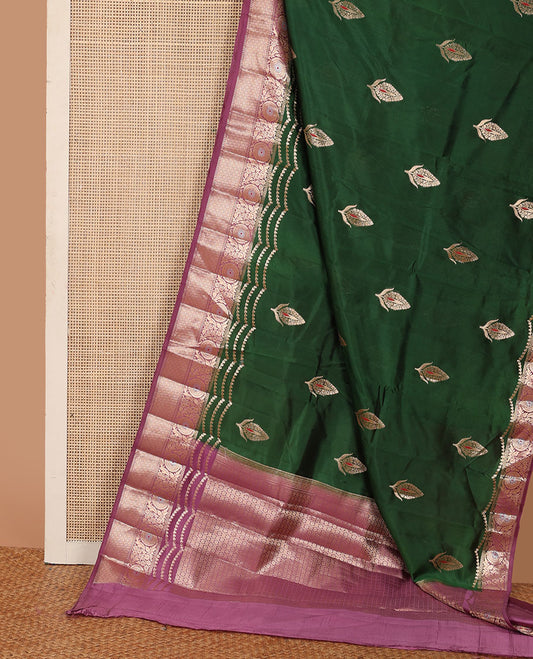 Dark green floral meena buttas raw mango silk saree, contrast floral design border creeper, and floral design pallu